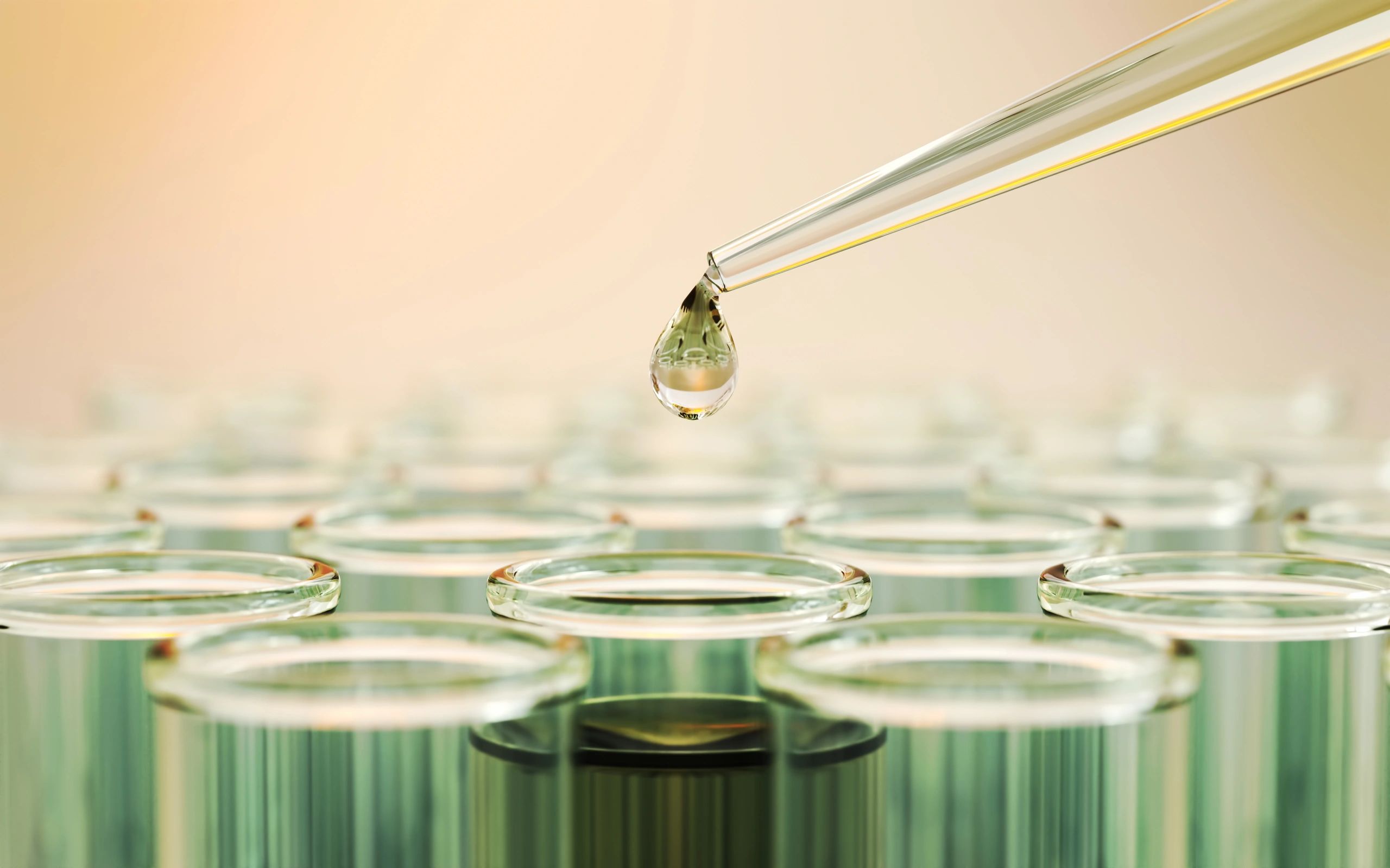 Laboratory glassware and pipette representing analytical testing